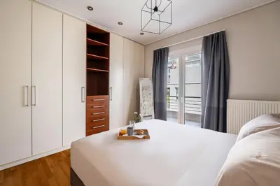 a bedroom with a large white bed and a window at Elegant 3BD Seaside Villa With Sea View In Vari in Vari