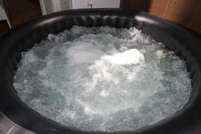 a pot filled with water in a bucket at Athens Central Jacuzzi Retreat in Athens