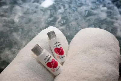 two bottles of moisturizers sitting on a towel at Athens Central Jacuzzi Retreat in Athens