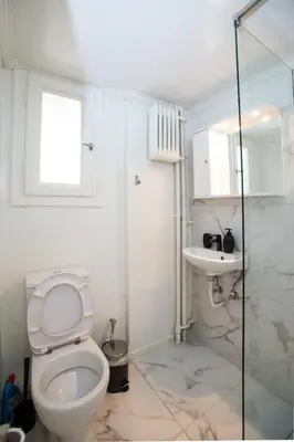 a bathroom with a toilet and a sink at Athens Central Jacuzzi Retreat in Athens