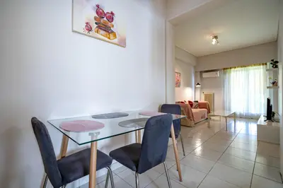 a dining room and living room with a table and chairs at Urban Nest In Chalandri by MΡS in Athens