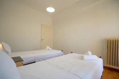 a room with two beds and a radiator at Urban Nest In Chalandri by MΡS in Athens