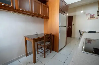 a small kitchen with a table and a refrigerator at Urban Nest In Chalandri by MΡS in Athens