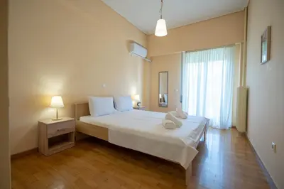 a bedroom with a large bed and a window at Urban Nest In Chalandri by MΡS in Athens