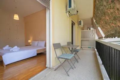 a small room with a bed and a table and chairs at Urban Nest In Chalandri by MΡS in Athens