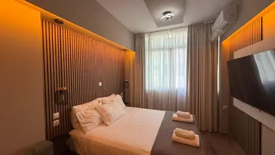 a bedroom with a bed with two towels on it at Monastiraki 303 SuperHost Hub in Athens