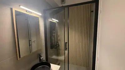 a bathroom with a shower with a sink and a mirror at Monastiraki 303 SuperHost Hub in Athens