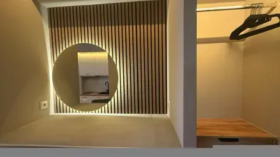 a circular mirror in a room with a kitchen at Monastiraki 303 SuperHost Hub in Athens