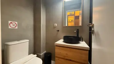 a bathroom with a white toilet and a sink at Monastiraki 303 SuperHost Hub in Athens