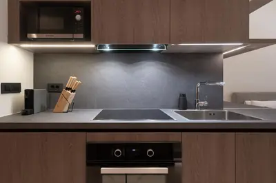 a kitchen with a sink and a microwave at Kolonaki Luxury Studios in Athens