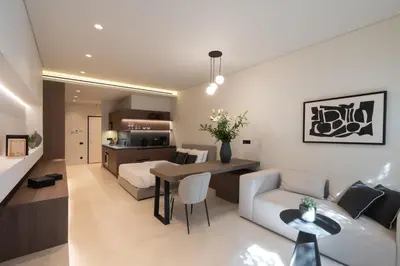 a living room and kitchen with a couch and a table at Kolonaki Luxury Studios in Athens
