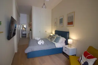 a bedroom with a bed with a teddy bear on it at Secret Garden by Acropolis - Athens Central Gem in Athens