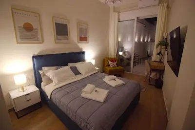 a bedroom with a bed with two towels on it at Secret Garden by Acropolis - Athens Central Gem in Athens