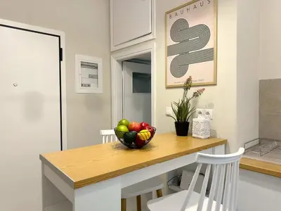 a kitchen with a bowl of fruit on a table at Secret Garden by Acropolis - Athens Central Gem in Athens