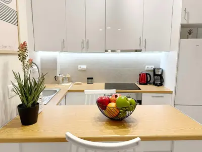 a bowl of fruit on a table in a kitchen at Secret Garden by Acropolis - Athens Central Gem in Athens