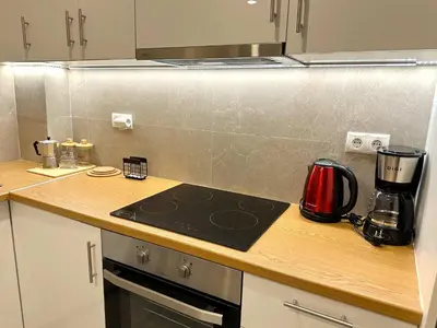 a kitchen with a counter top with a stove top oven at Secret Garden by Acropolis - Athens Central Gem in Athens