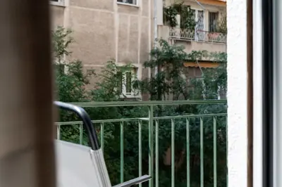 a balcony with a chair and a building at Relax & Comfy 2BR Apt Close To Athens Center in Athens