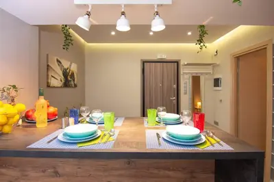 a table with plates and glasses on top of it at 2 bedroom apartment few steps from Plaka in Athens