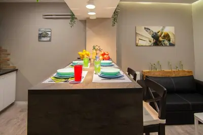 a table in a kitchen with a dining room at 2 bedroom apartment few steps from Plaka in Athens