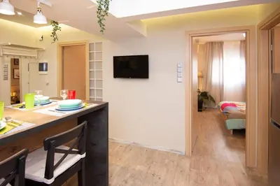 a kitchen and living room with a counter and a table at 2 bedroom apartment few steps from Plaka in Athens