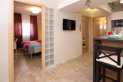 a room with a living room with a tv on a wall at 2 bedroom apartment few steps from Plaka in Athens