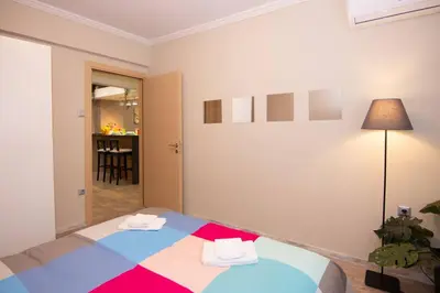 a room with a bed with two towels on it at 2 bedroom apartment few steps from Plaka in Athens