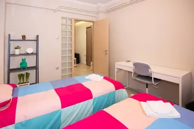 a room with two beds and a desk and a desk at 2 bedroom apartment few steps from Plaka in Athens