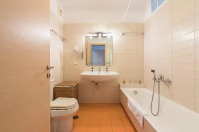 a bathroom with a toilet and a sink and a tub at Cozy Athens 2bdr Apartment in Athens