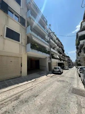 a street with cars parked on the side of a building at Cozy Athens 2bdr Apartment in Athens