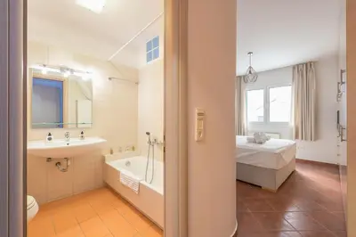 a bathroom with a bed and a tub and a sink at Cozy Athens 2bdr Apartment in Athens