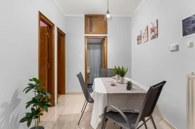 a dining room with a table and chairs at Adigonis Apartment next to the metro station in Athens
