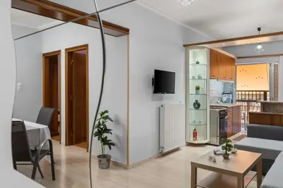 a living room with a couch and a table at Adigonis Apartment next to the metro station in Athens
