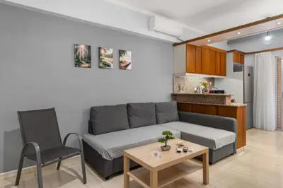 a living room with a couch and a table at Adigonis Apartment next to the metro station in Athens