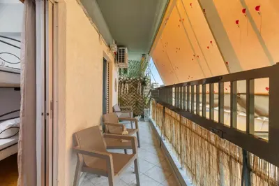 a row of chairs sitting on a balcony at Adigonis Apartment next to the metro station in Athens