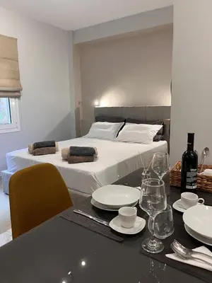a bedroom with a bed and a table with plates and glasses at Athens Urban Retreat Apartment - City Center - Fiber Wi-Fi in Athens