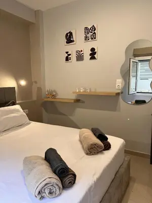 a bedroom with a bed with towels on it at Athens Urban Retreat Apartment - City Center - Fiber Wi-Fi in Athens