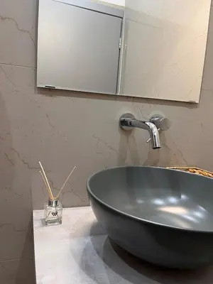 a bathroom with a bowl sink and a mirror at Athens Urban Retreat Apartment - City Center - Fiber Wi-Fi in Athens
