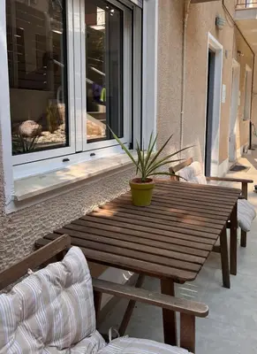 a wooden table with a potted plant on a patio at Athens Urban Retreat Apartment - City Center - Fiber Wi-Fi in Athens