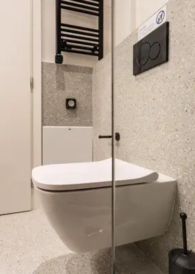 a bathroom with a white toilet in a room at KLEO by Zoia Living in Athens