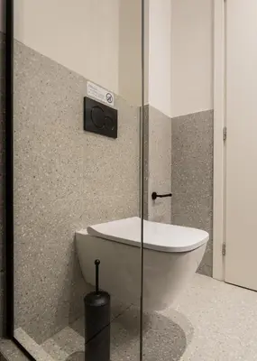 a bathroom with a toilet and a glass shower at KLEO by Zoia Living in Athens