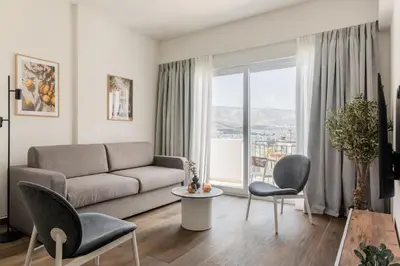 a living room with a couch and chairs at KLEO by Zoia Living in Athens