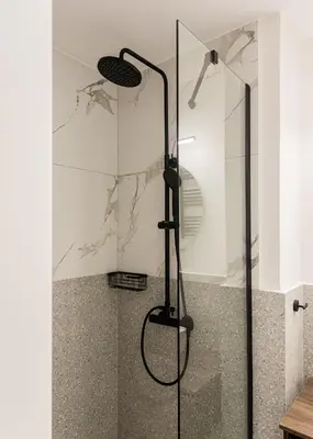 a shower with a glass door in a bathroom at KLEO by Zoia Living in Athens