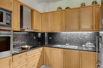 a kitchen with wooden cabinets and a sink at Aura in Piraeus
