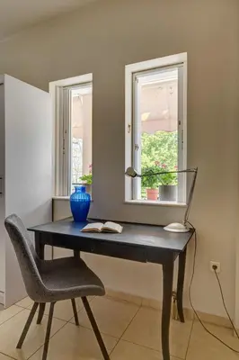 a desk in a room with a chair and a window at Aura in Piraeus