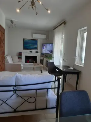a bedroom with a bed and a living room at Aura in Piraeus