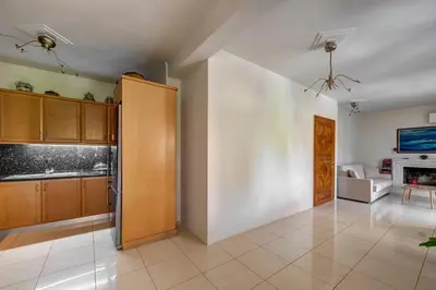 a kitchen with a door open to a living room at Aura in Piraeus