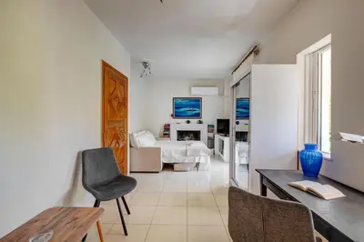 a living room with a bed and a table and chairs at Aura in Piraeus