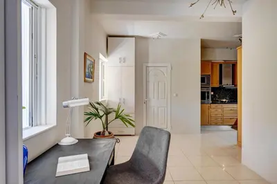 a living room with a table and a chair at Aura in Piraeus