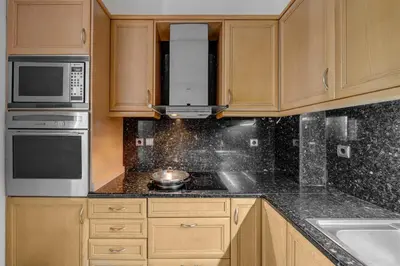 a kitchen with wooden cabinets and a stove top oven at Aura in Piraeus