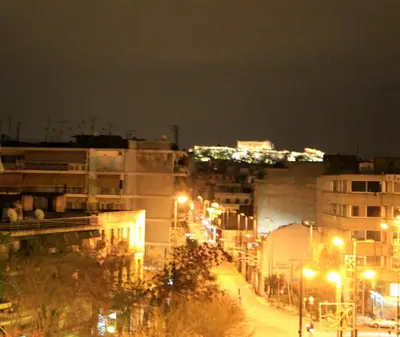 a city street at night with buildings and street lights at Athens Lydia Hotel in Athens